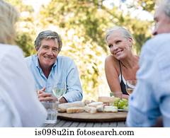 Friends at meal outdoors