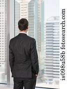 Rear view of businessman looking out of office window