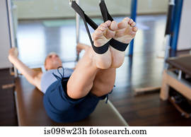 Woman doing pilates in gym