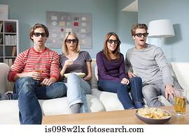 Four friends watching 3d movie at home