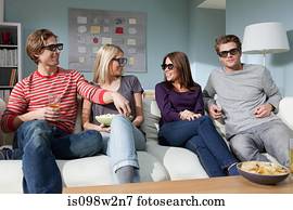 Four friends watching 3d movie at home