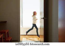 Girl running past doorway