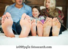 Family on bed with barefeet