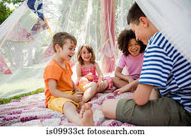 Four friends in summer netting tent