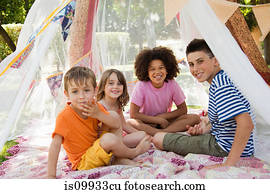Four friends in summer netting tent