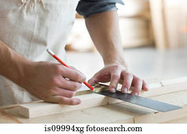 Carpenter using mitre in workshop