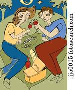 A couple having a picnic at night A couple having a picnic at night