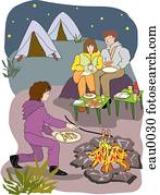 A family enjoying dinner by the campfire