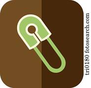 A green baby safety pin on brown background