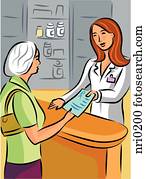 A pharmacist handing over a prescription to an elderly woman A pharmacist handing over a prescription to an elderly woman