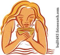 A woman breathing in aromatherapy vapors A woman breathing in aromatherapy vapors