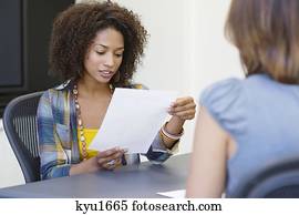 mulher americana africana, leitura, um, retomar, enquanto, levando, entrevista, de, um, caucasiano, mulher