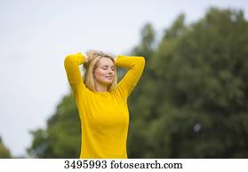 Blonde woman breathing fresh air in the park