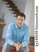 Man sitting, joining hands