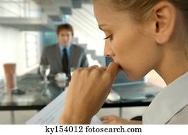 Businesswoman in office with colleague in background