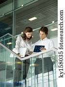 Businessman and a businesswoman looking at the documents