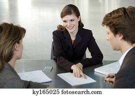 Real estate agent explaining a contract to a couple