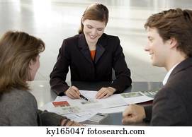 Real estate agent explaining to a couple