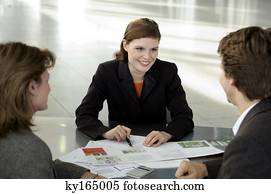 Real estate agent explaining to a couple