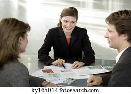 Real estate agent explaining to a couple