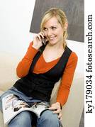 mulher jovem, sentando, ligado, um, sofá, e, conversa num telefone móvel