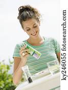 Woman seasoning salad