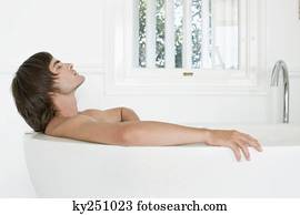 Man lying in a bathtub