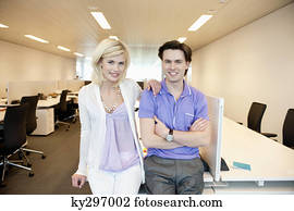 Business couple smiling in an office