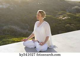 Mid adult woman meditating