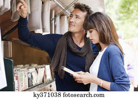 Couple choosing books at a book stall, Paris, Ile-de-France, France