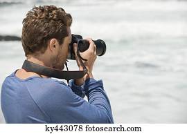 Man photographing on the beach