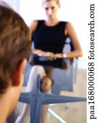 Businesswoman sitting at table across from businessman