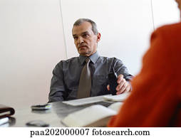 Businessman sitting at table.