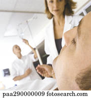 Doctor taking patient's pulse in emergency room