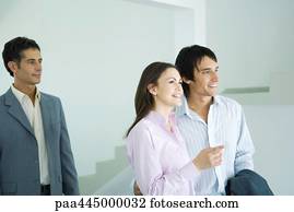 Real estate agent showing home to young couple