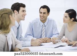 Businessman sitting with colleagues at conference table