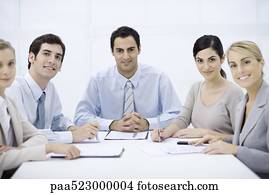 Businessman sitting with colleagues at conference table