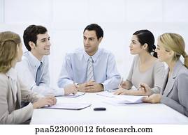 Businessman sitting with colleagues at conference table