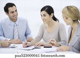 Businessman sitting with colleagues at conference table