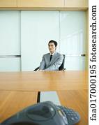 Businessman sitting at conference table