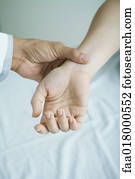 Doctor taking woman's pulse, close-up