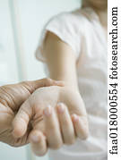 Doctor taking woman's pulse, close-up