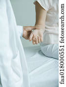 Doctor taking woman's pulse, close-up