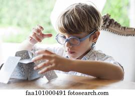 Little boy building house of cards