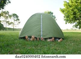 Young friends in tent, feet sticking out