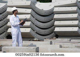 Man in work uniform writing on clipboard