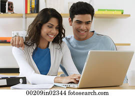 Young couple using laptop Young couple using laptop