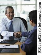 Indian business men shaking hands and smiling Indian business men shaking hands and smiling