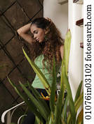Young woman holding hair and looking down Young woman holding hair and looking down