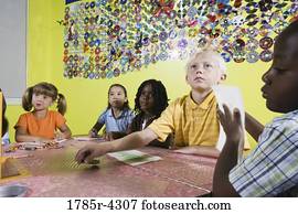 Children drawing and paying attention in art class